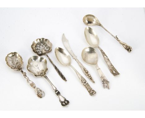 A collection of continental white metal Art Nouveau caddy spoons, butter knives, preserve spoons, etc, including a Danish sil