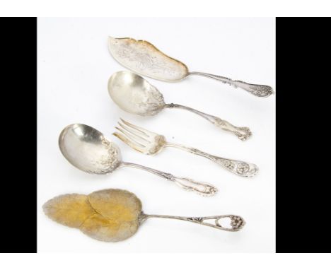 A collection of silver plated and white metal serving implements, including asparagus forks, fish slices, cake slices, berry 