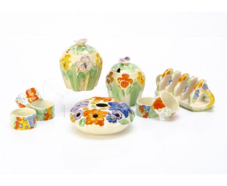A pair of Wade Heath Art Deco pottery moulded preserve jars and covers, of ovoid shape decorated with flowers, green stems, d