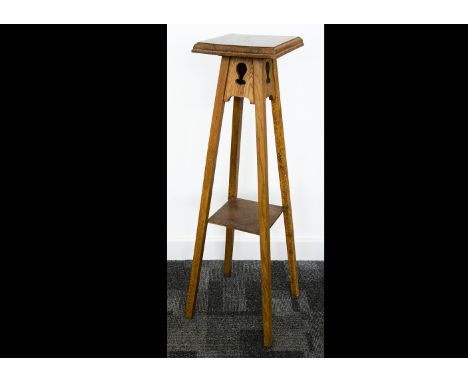 Three Art Nouveau occasional tables, all in oak, two with circular tops both on tripod pierced supports with lower stretcher,