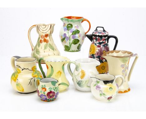 A collection of Art Deco and later jugs, some by Myott &amp; Sons, Wade Heath, all decorated with painted flowers, a J H W &a