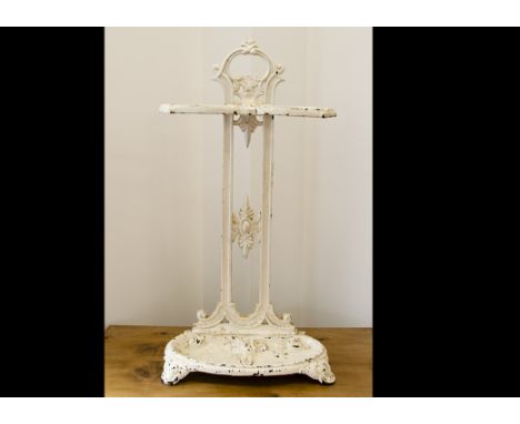 A cast iron painted stick stand, the 19th Century cast iron stick stand with Art Nouveau decorated semi circular scroll well 