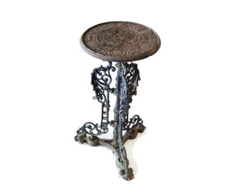 A cast iron garden table, the small circular top with moulded design on single pedestal with three griffin bracket supports o