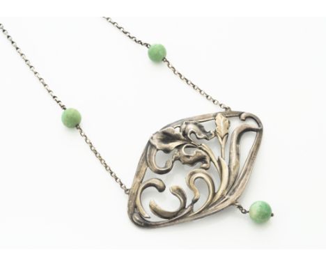 A continental white metal Art Nouveau jade set pendant necklace, the lozenge shaped pendant with stylised iris design, suppor