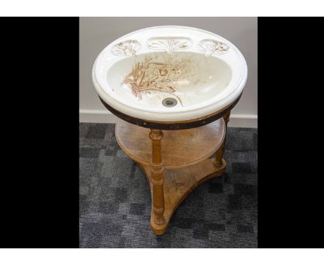 An Edwardian wash basin, the pottery circular top in an Aesthetic design decorated with birds within reeds by Cauldron Englan