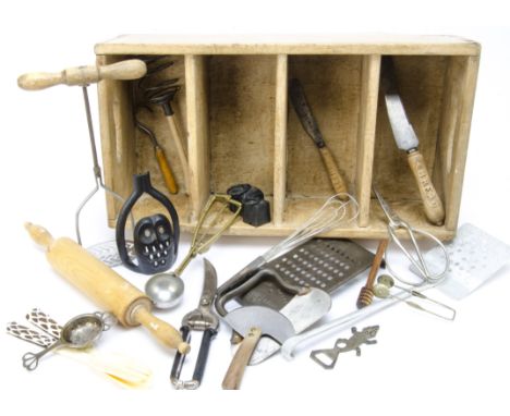 A collection of kitchen implements, contained in a four division handled tray, including a rolling pin, potato masher with tu