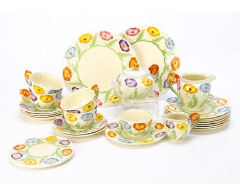 A collection of Grindley Art Deco pottery teaware, of moulded design, of floral decoration, each flower painted in blue, oran