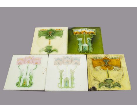 Five J &amp; W Wade &amp; Company Art Nouveau pottery tiles, relief moulded with stylised floral decoration, painted in vario