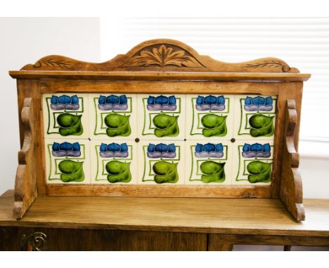 An Art Nouveau washstand tiled dressing table back, the stylised floral blue, mauve and green flowers within a pine frame wit