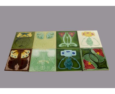 Eight Marsden Art Nouveau relief moulded tiles, floral design painted in colours, 15cm square Some are crazed^ minor chips to