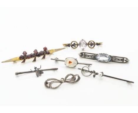 Seven early 20th Century bar brooches, including garnet set gilt metal clover brooch, amethyst and rope twist example, a past