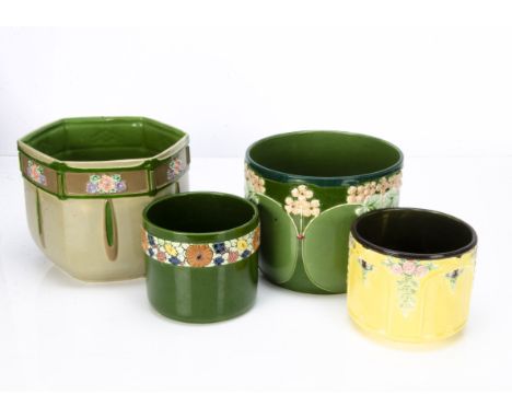 Four Eichwald Art Nouveau German pottery jardinières, including a hexagonal example with floral spray against a green and bro