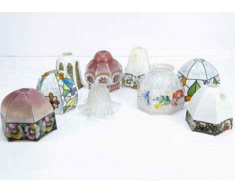 A collection of Art Deco glass shades, of various sizes and shapes, mostly of faceted open forms, all transfer printed with f