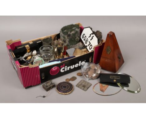 A box of collectables including a metronome, vintage compass, pre-decimal coins, empty Chanel No. 5 perfume bottles, etc.