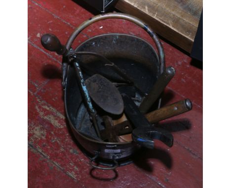 A painted metal and brass coal scuttle and contents of metalwares including shoe last, hand tools etc.