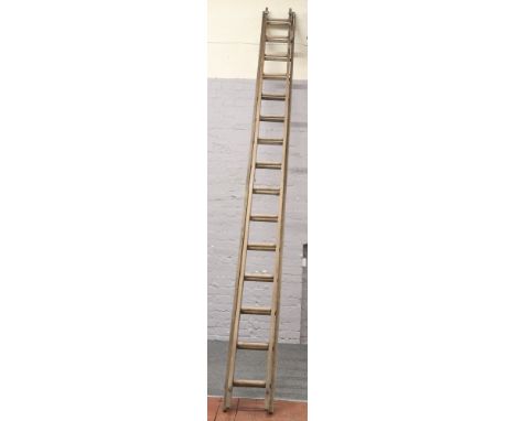 A vintage wooden double ladder with 15 rungs.