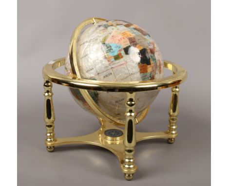 A hardstone rotating globe on gilt metal stand, height approx 32cm.