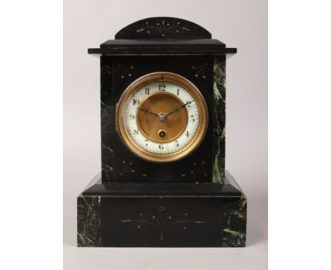 A late 19th / early 20th century black slate 30 hour mantle clock with green marble embellishments with pendulum.