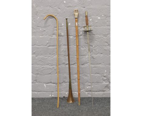 Two canes one with owl pommel, along with a decorative sword and a copper and brass bugle.