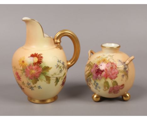 A Royal Worcester blush ware flat back jug and a similar globular vase with loop handles and raised on ball feet, both enamel