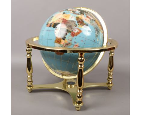 A large hardstone rotating globe on gilt metal stand, height approximately 45cm.