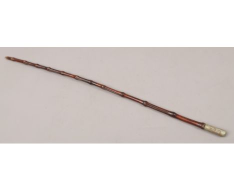 A World War I George V military swagger stick with cane shaft and white metal terminal.