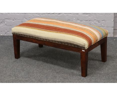 An Indian Zanskar Kilim covered double stool, 90cm Length x 45cm Width.