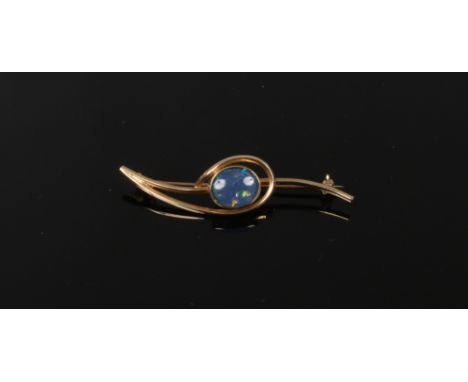 A vintage 9ct gold scrolling openwork bar brooch, set with a large ovoid opal doublet.