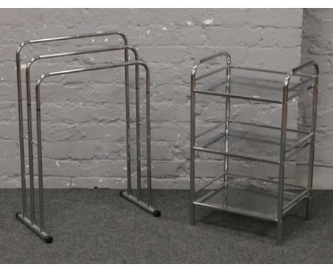 A chrome three bar towel rack along with bathroom three tier stand.