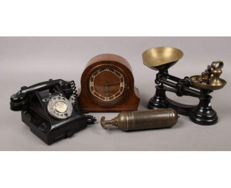 A cast iron set of weighing scales and bell weights, along with a vintage oak dome top mantle clock, vintage brass Beano fire