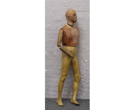 A vintage shop mannequin with jointed arm.