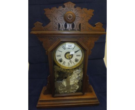 A late 19th Century walnut cased mantel clock, the eight day German movement with circular dial and gilded glass 
