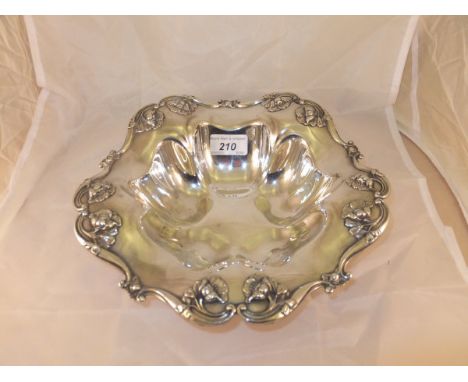 An American white metal bowl of stylised floral form with applied floral edge, stamped "R Sterling 470" to back