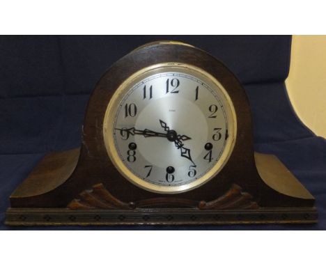 An oak cased Napoleon hat shaped mantel clock, the steel dial with Arabic numerals marked "Enfield"