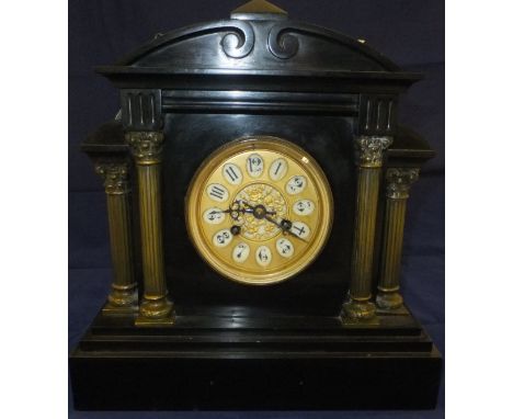 A mantel clock in polished slate, with Arabic numerals to the brass dial, together with two resin figures of Oriental man and