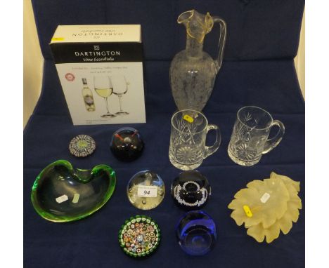 Assorted Dartington crystal wine glasses, glass commemorative mugs, various glass paperweights including Caithness, two mille