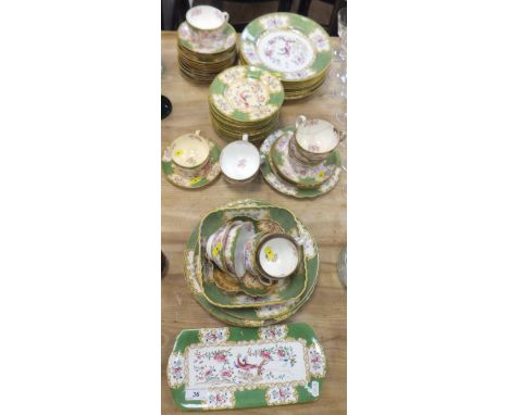 A late 19th / early 20th Century Minton's porcelain part tea service decorated with panels depicting flowers and ho ho birds,