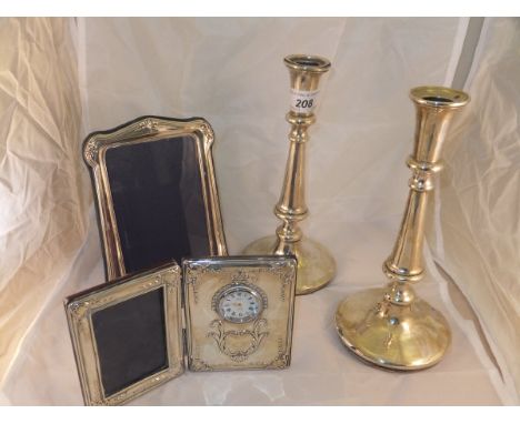 A pair of silver candlesticks in the 18th Century manner, on circular bases (Birmingham, 1911)
together with a modern silver 