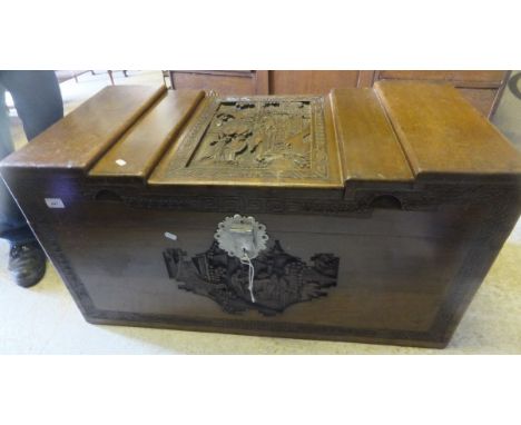 A Far Eastern carved camphor wood trunk with figural decoration CONDITION REPORTS Approx 101 x 50cm x 50cm high.  Wear, chips