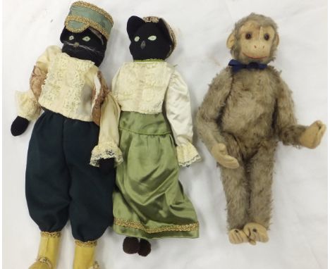 A vintage plush monkey toy in the Steiff manner, with felt feet, hands and face, together with two cat soft toys