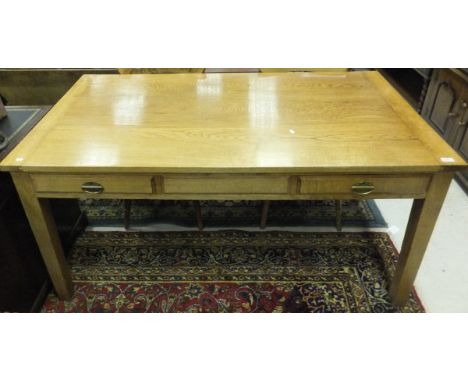 A modern light oak farmhouse kitchen table with two frieze drawers, on square tapering legs