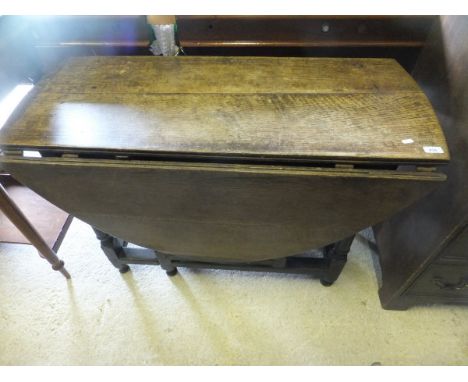 An 18th Century oak oval gate-leg drop-leaf dining table