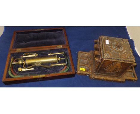 A 19th Century lacquered brass and carved bone enema housed in original mahogany casing, together with a 20th Century syroco 