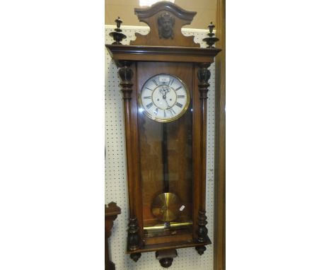 A Victorian walnut cased Vienna style regulator wall clock, the circular enamel dial with Roman numerals to the chapter ring