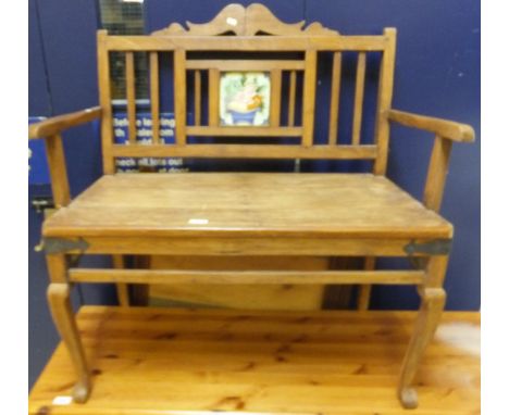 A modern French bench of small proportions, the back set with decorative tile, above a plain plank seat, raised on cabriole f