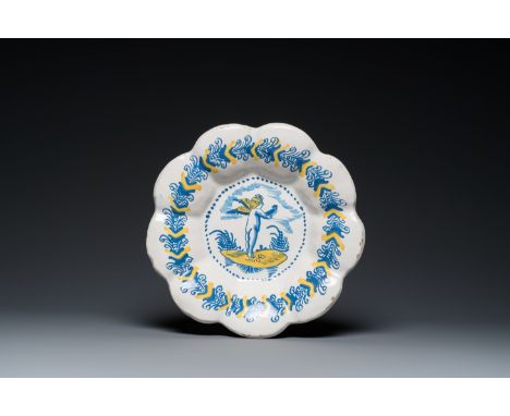 Full title: A blue, white and yellow Dutch Delftware dish with a putto holding a falcon, Delft or Haarlem, 17th C.Description