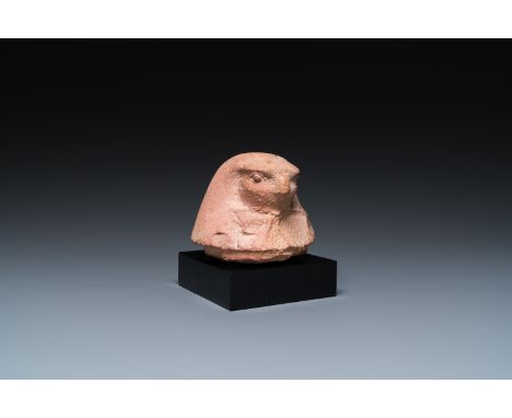 Full title: An Egyptian light brown limestone canopic lid in the shape of a falcon head, Late PeriodDescription:H.: 11 cm (in