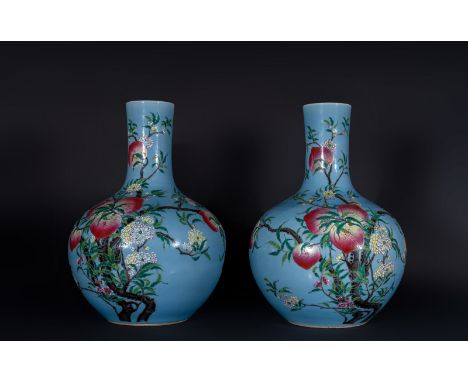 Chinese Art Pair of large tianqiuping porcelain vases with a light blue ground decorated with peaches, flowers and batsChina,