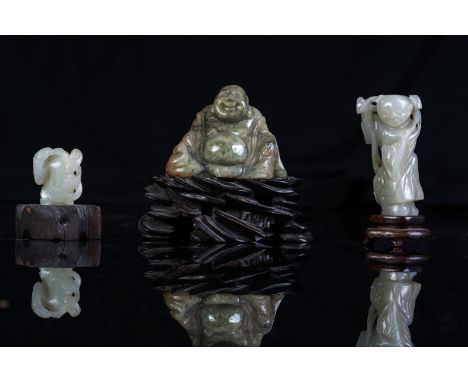 Chinese Art Two small white jade figures and a jadeite seated Budai China, 19th century . . Cm 7,00 x 9,00. wooden stand.