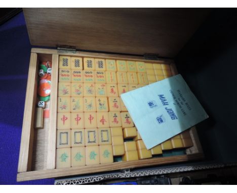 A vintage Mah Jong set in wooden box with instruction booklet